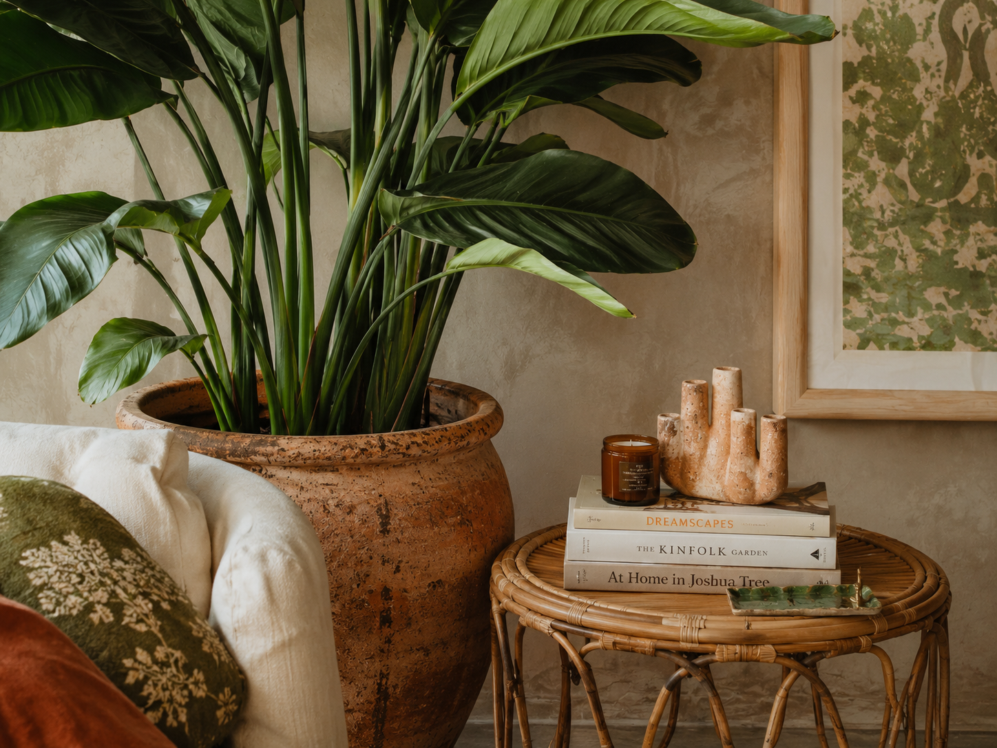 Summer living room plant styling with terracotta pots and natural textures